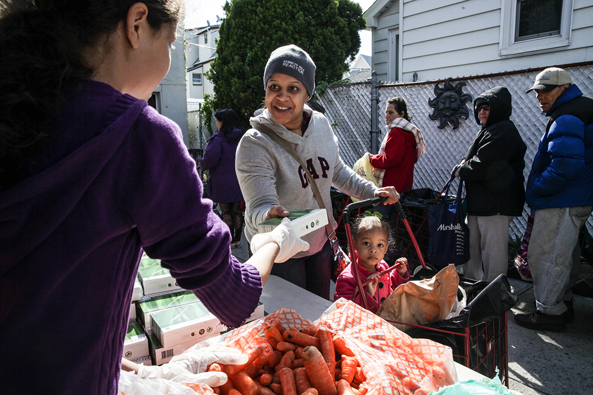 mission_moment Food Bank NYC patron receives food amid benefit delays