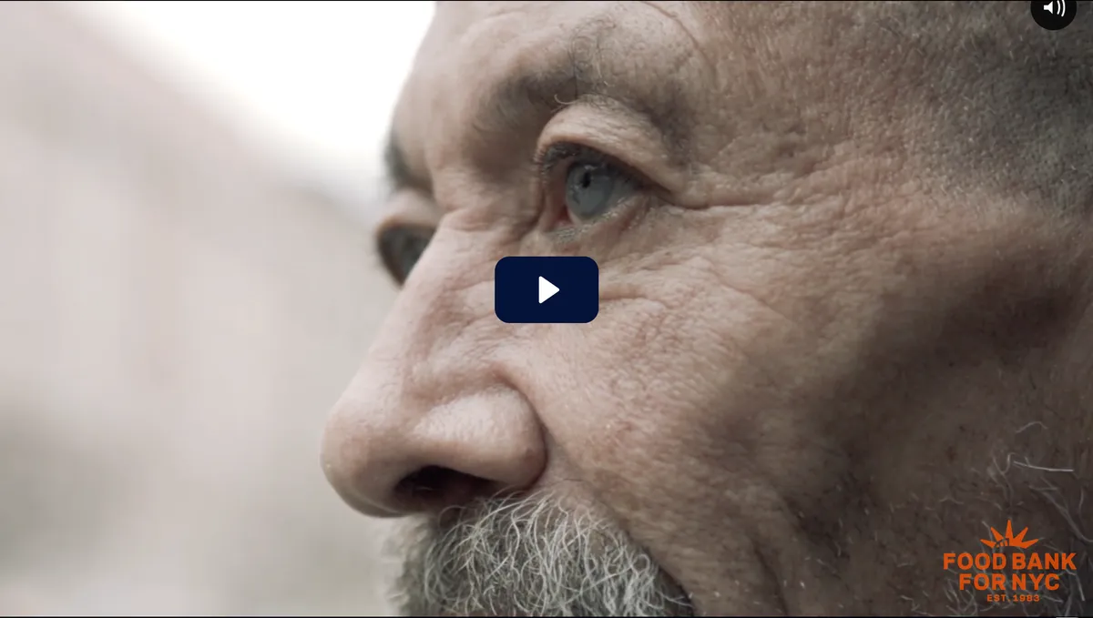A close-up of a person's hand, with their fingers gently curled, against a softly blurred background of muted colors.