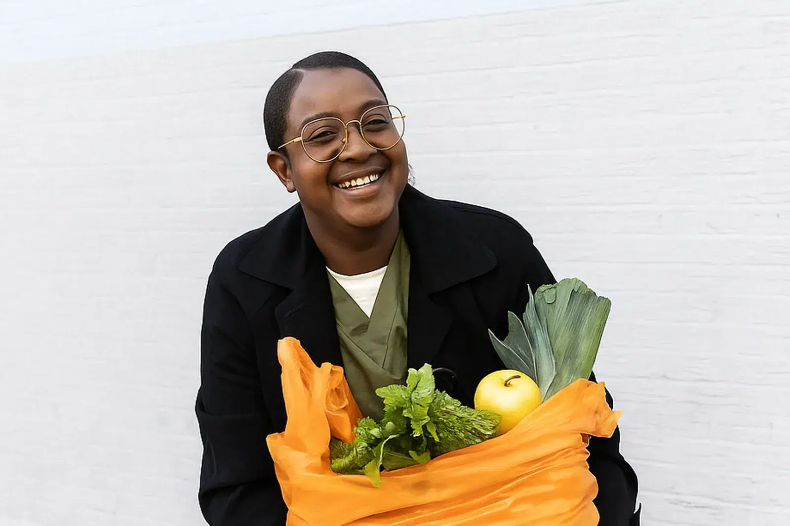 Holding bag of fresh produce Smiling woman holding bag of fresh produce