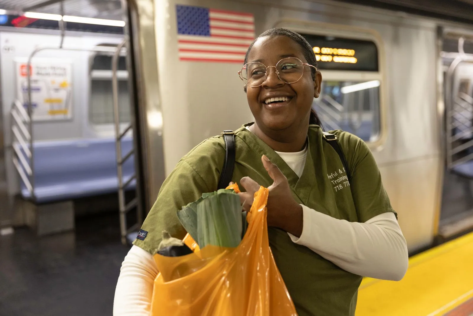 2_Volunteer distributing produce at community food event Volunteer distributing produce at community food event
