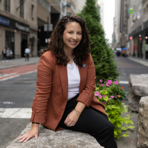 Stefanie Shuman smiles for her headshot in the streets of NYC.
