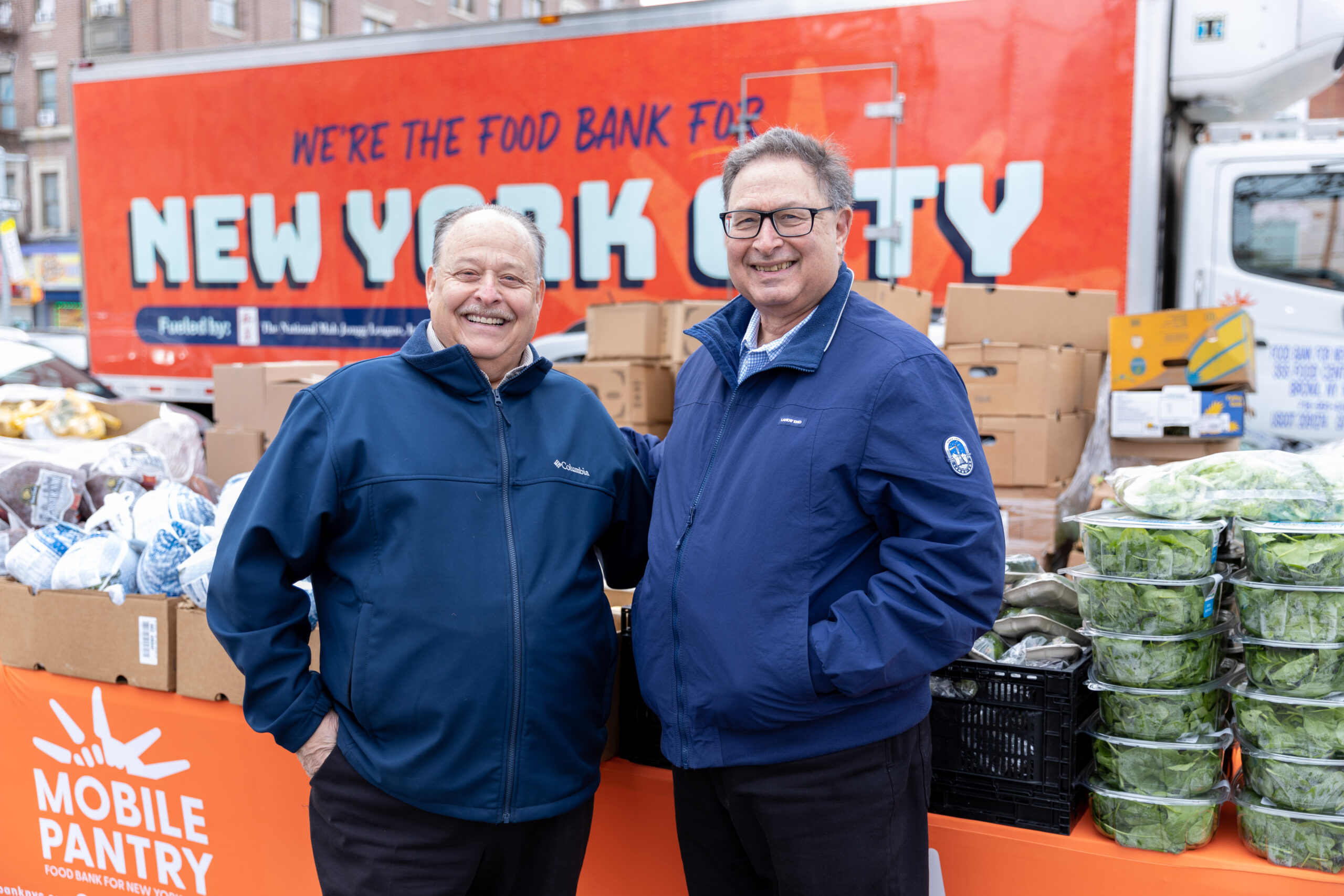 National Mah Jongg League brothers Larry and David Unger pose in front of their donated Food Bank For NYC truck.