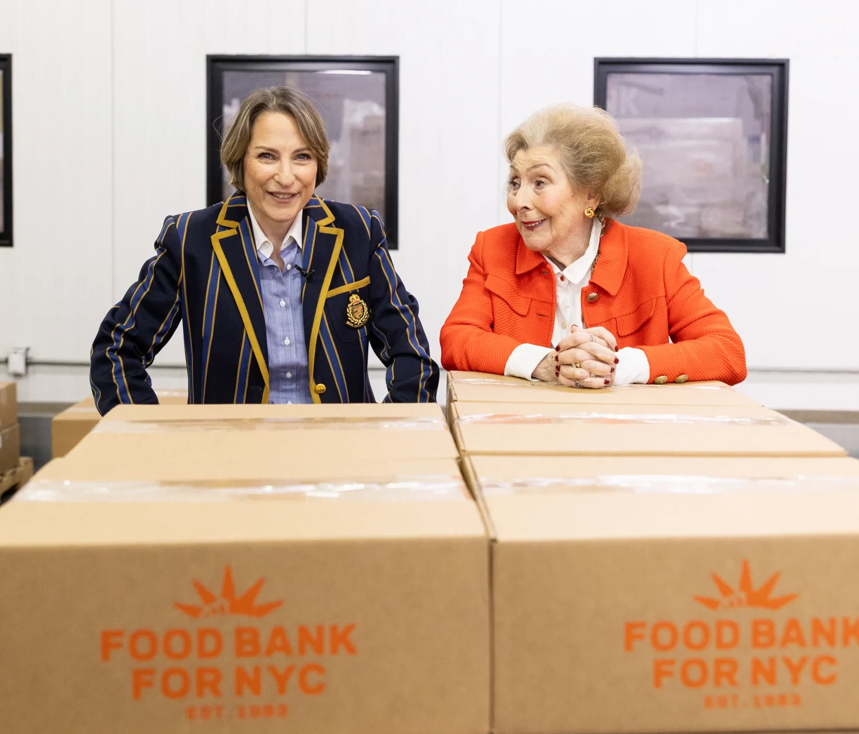 Leslie Gordon, CEO of Food Bank For NYC, and her mother Myra Gordon, former Hunts Point Produce Market director, laugh amid boxes of fresh produce.