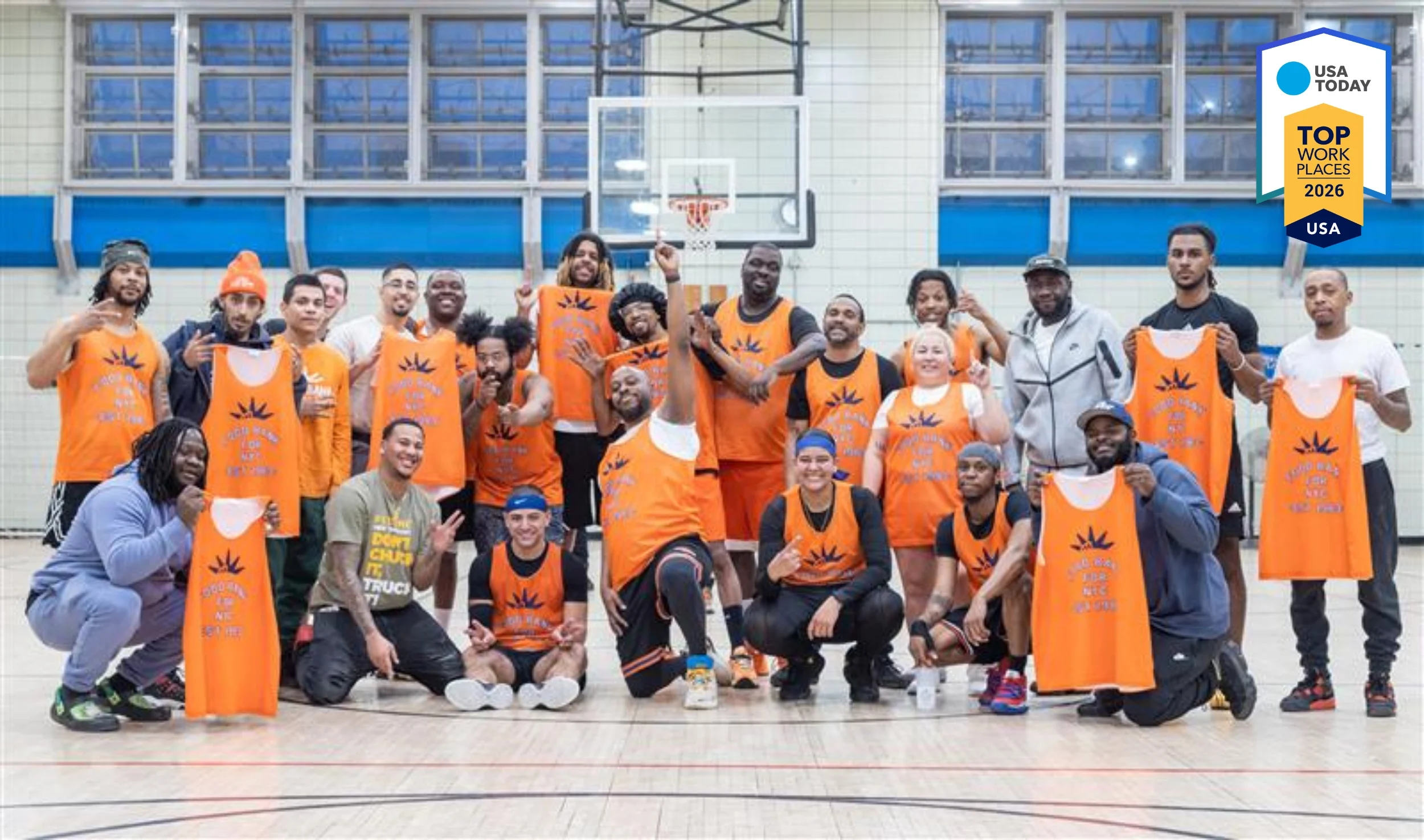 Food Bank For NYC team members smile in branded jerseys after playing a basketball game organized by People & Culture.