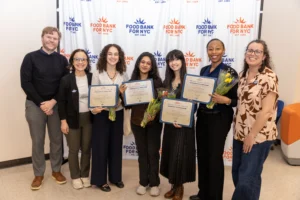 Food Bank For NYC leaders Nicole Hunt, Nic Burgess, and Carmen Boone celebrate graduates of the inaugural Emerging Leaders Advocacy Council during the program’s graduation ceremony in Harlem.