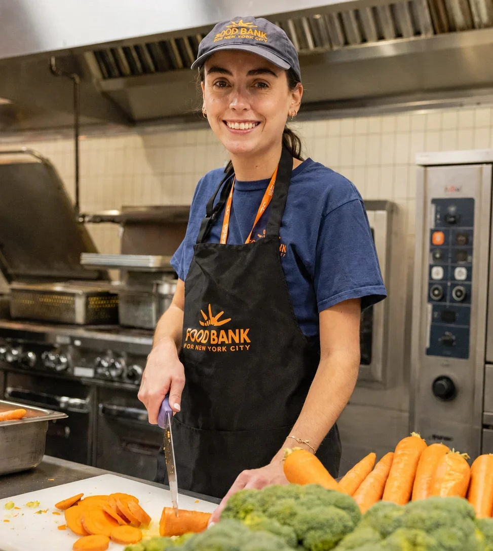 Director of Volunteer Engagement Nicole Harrison cuts carrots at the Food Bank For NYC Community Kitchen.